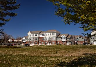 a row of town houses overlooking a field