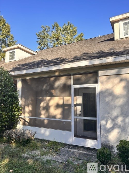 A house with a white door and a brown roof.
