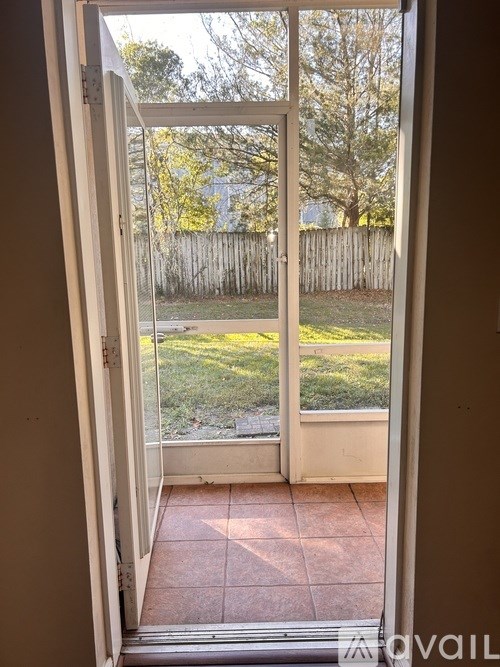 A view of a backyard through a sliding glass door.