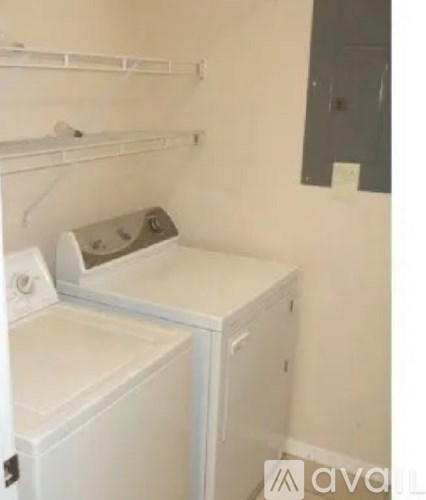 A small laundry room with a washer and dryer.
