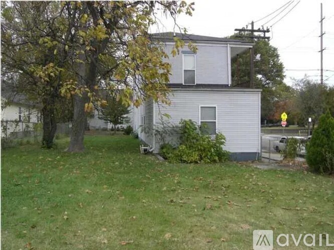 A house with a tree in front of it.