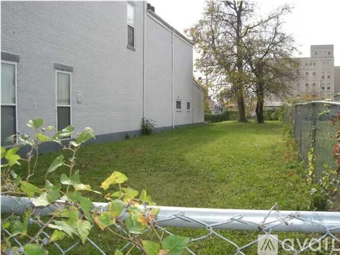 A white building with a fence in front of it.
