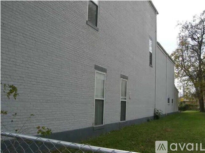 A white building with a fence in front of it.