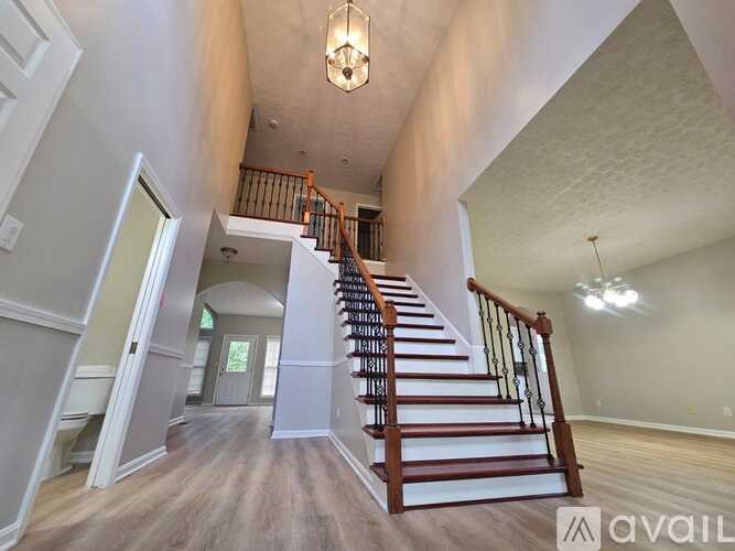 A spacious interior with a staircase leading to the upper floor.