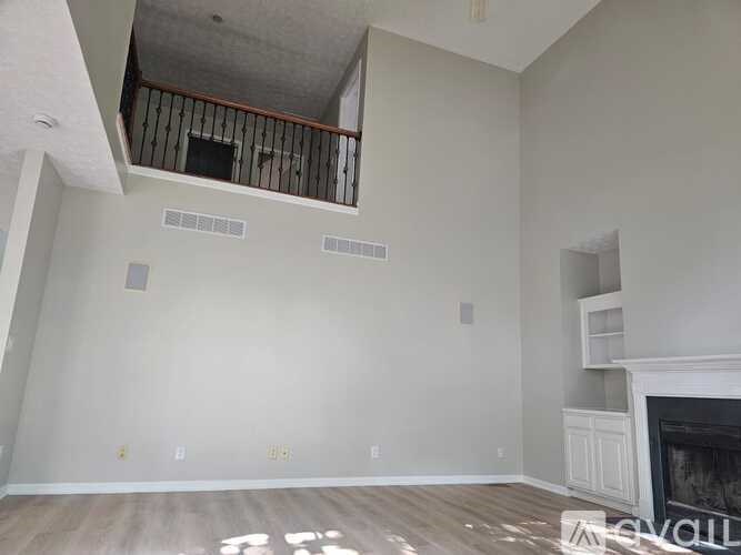 A room with a fireplace and a balcony.