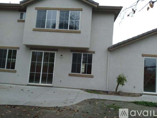 A house with a tree in front of it.