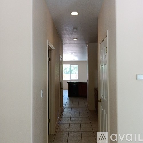 A long hallway with a door on the right.