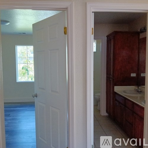 A white door is open to a bathroom.