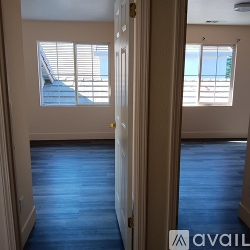 A room with a view of a pool through the window.