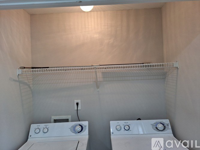 A small laundry room with two washing machines.