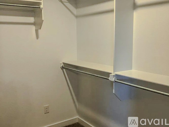 A metal shelf bracket is attached to a white wall.