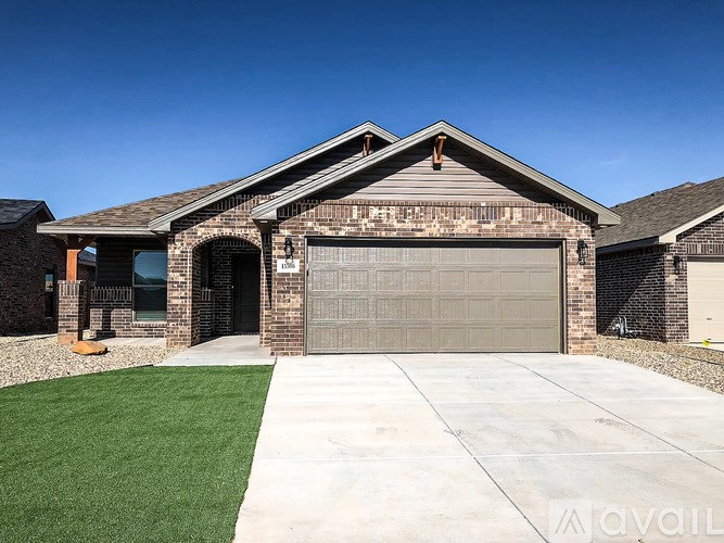 A house with a garage and a driveway in front.