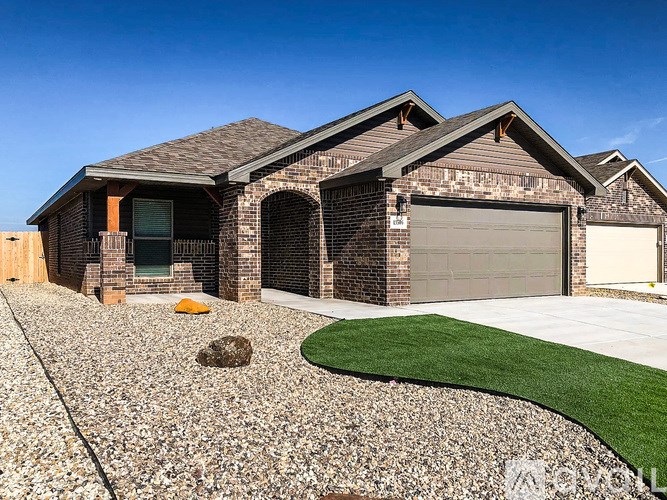 A house with a grey roof and a garage door.
