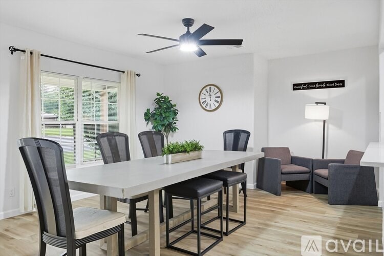 A dining room with a table and chairs.