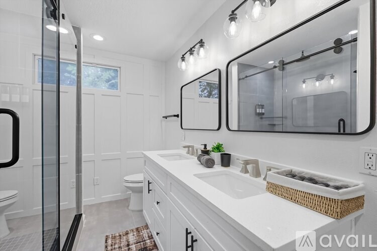 A bathroom with a white counter and a large mirror.