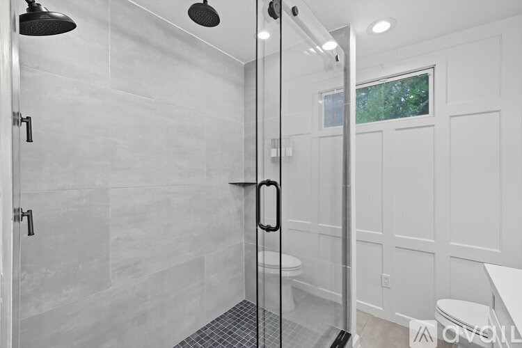 A white bathroom with a walk in shower.