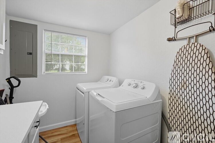 A small laundry room with a washer and dryer.