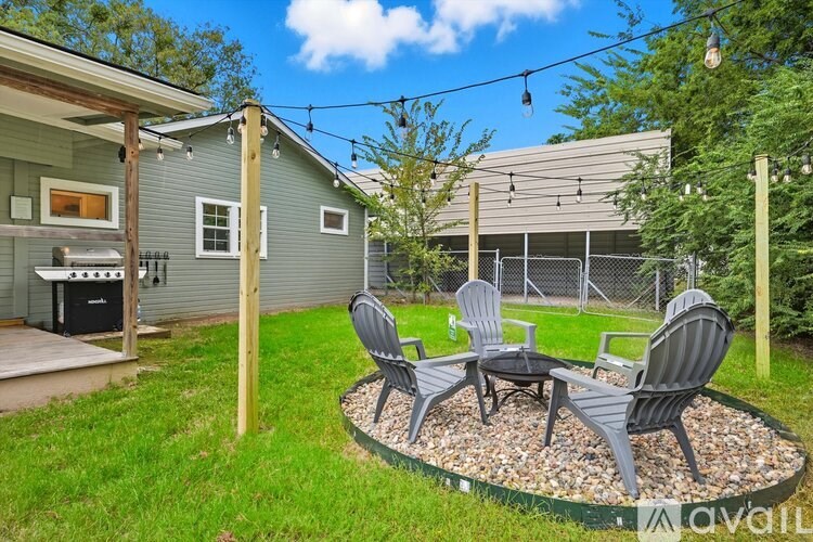 A backyard with a table and chairs set up.