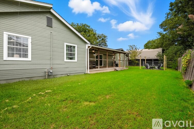 A house with a green lawn and a clear blue sky.