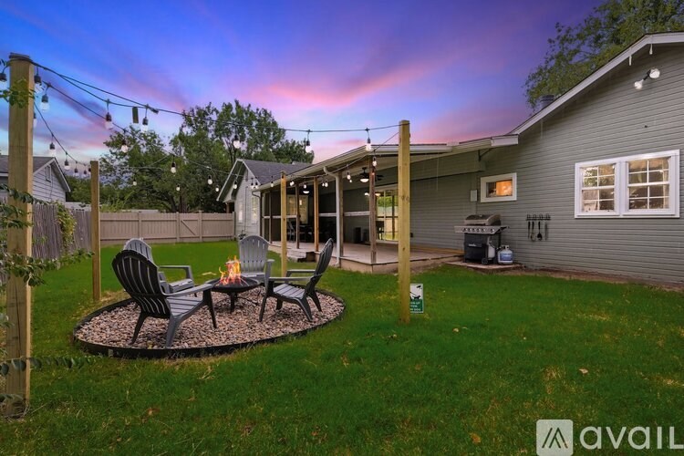 A backyard with a patio and chairs.