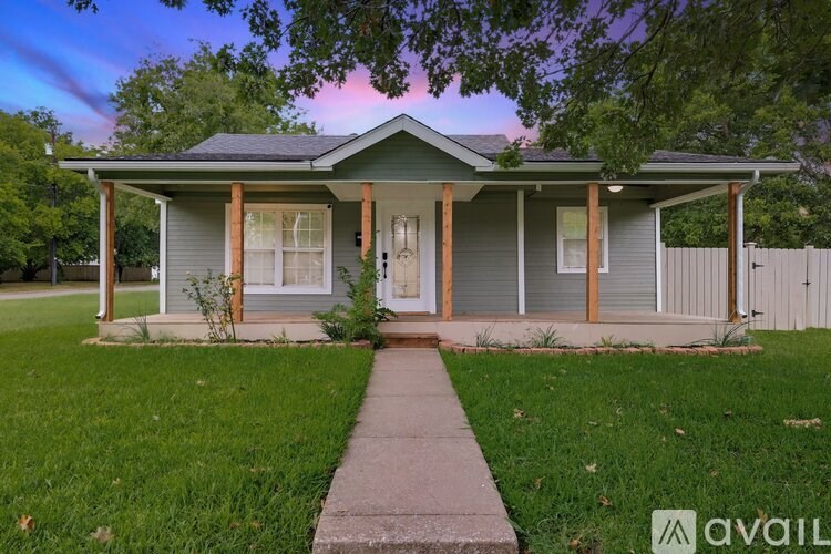 A house with a porch and a walkway leading to the front door.