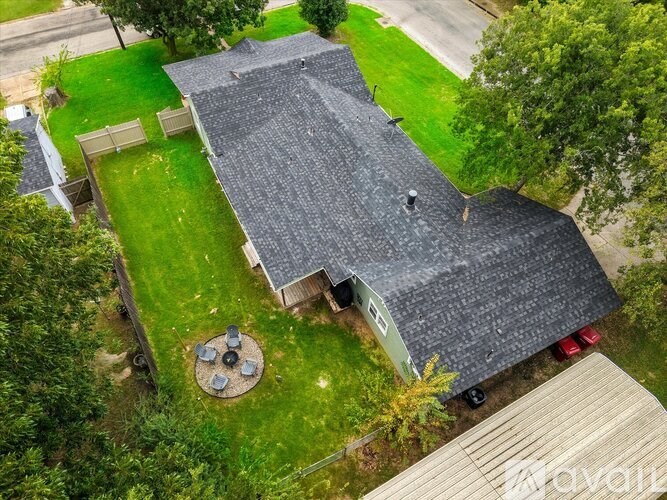 A house with a grey roof and a green lawn.