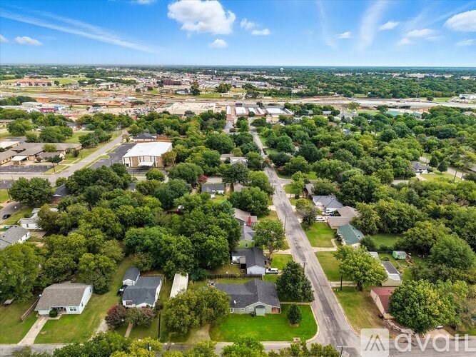 A bird's eye view of a residential area with houses and trees.