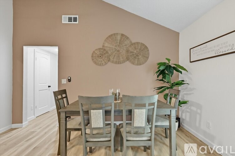 A dining room with a wooden table and chairs.