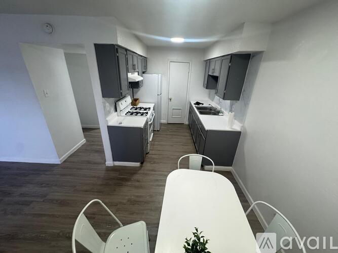A small kitchen with a table and chairs.
