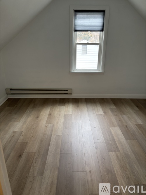 A room with a window and a radiator on the wall.