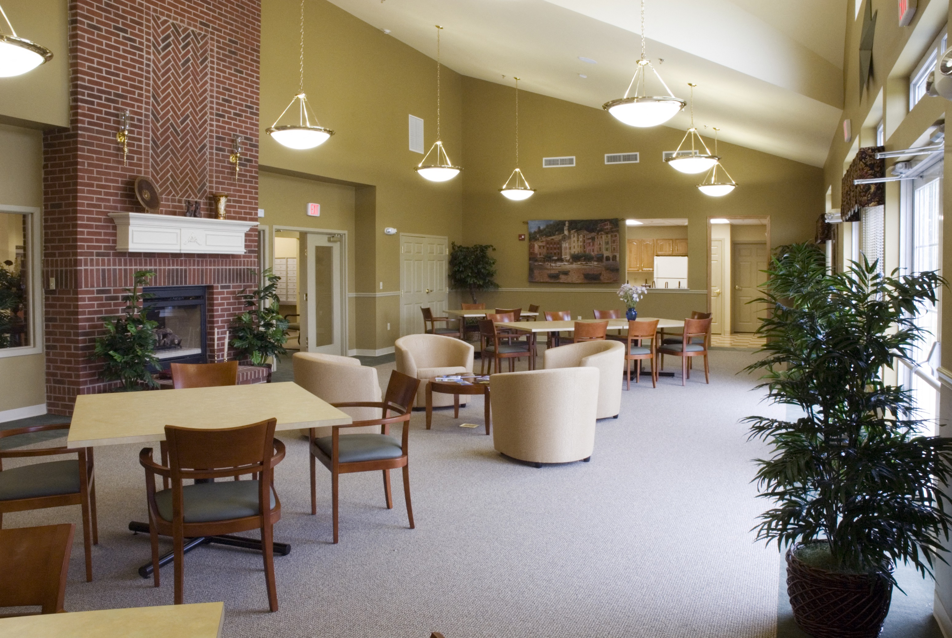 a large room with tables and chairs and a fireplace