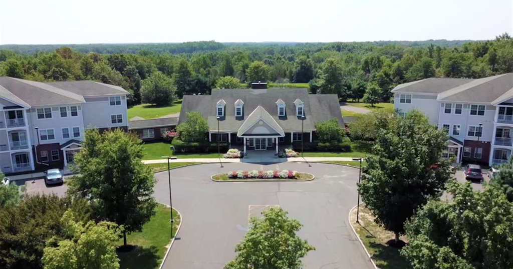 an aerial view of a house in a neighborhood with trees