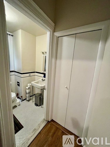 A bathroom with a white cabinet and a mirror.