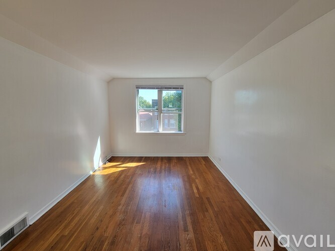 A room with wooden floors and a window.