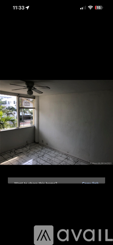 A room with a ceiling fan and a window showing daylight.