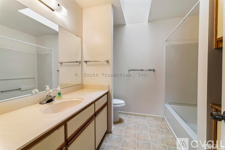 A bathroom with a sink, toilet, and shower.