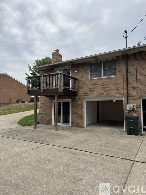 A two-story house with a balcony and a garage.
