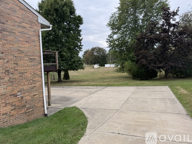 A brick building with a concrete walkway in front.