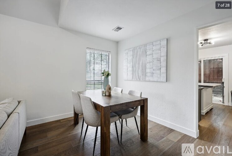 A dining room with a table and chairs.