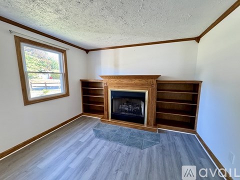 A room with a fireplace and a window.