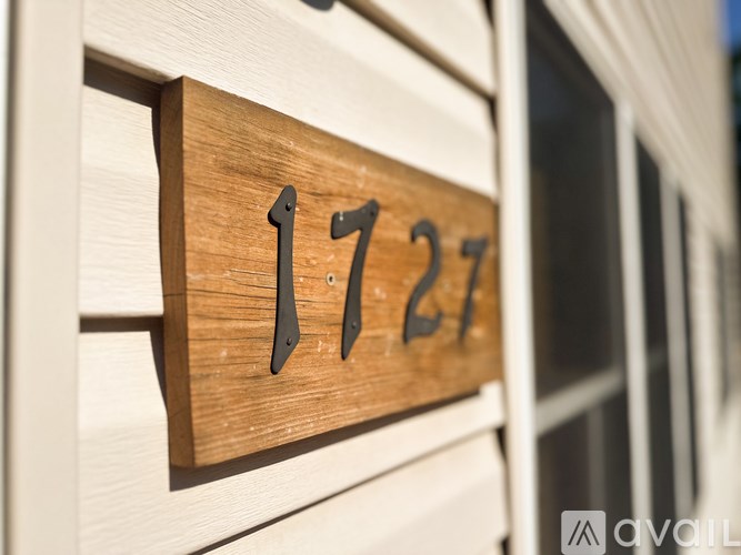 A wooden house number sign with the number 1727 on it.