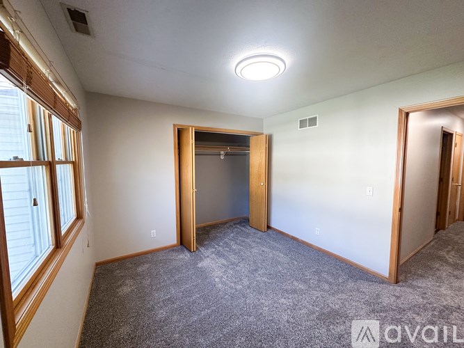 A room with a carpeted floor and a ceiling light.