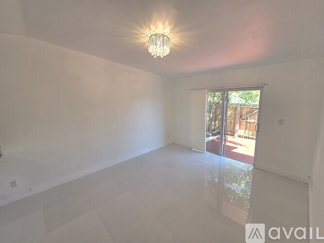 A kitchen with white cabinets and a white floor.