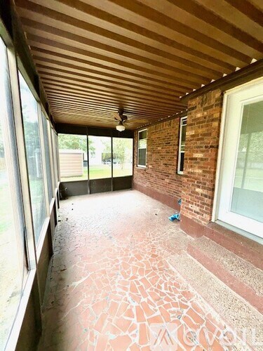 A room with a brick wall and a wooden ceiling.