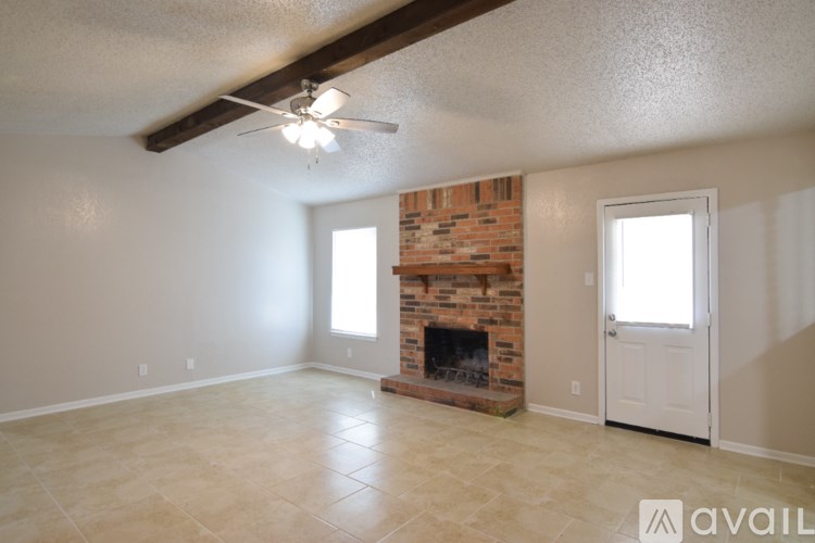 A room with a fireplace and a ceiling fan.