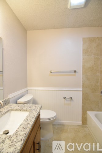 A bathroom with a sink, toilet and bathtub.