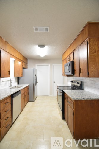 A kitchen with wooden cabinets and a white refrigerator.