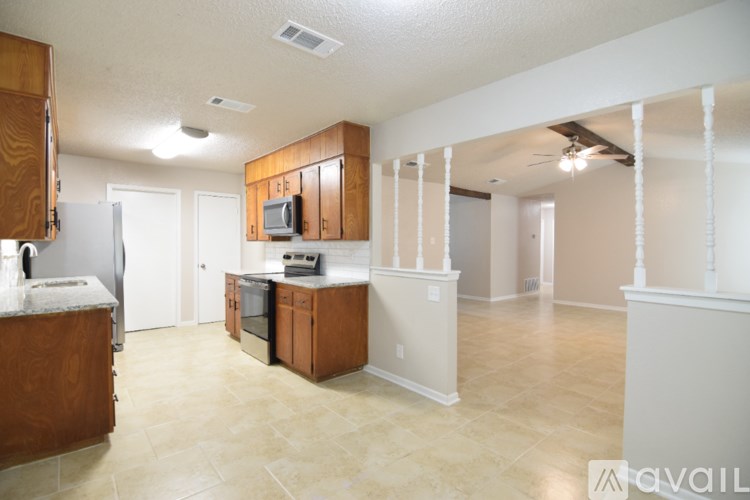 A kitchen with wooden cabinets and a white refrigerator.