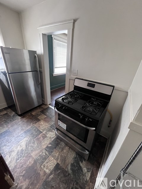 A kitchen with a stove and a refrigerator.