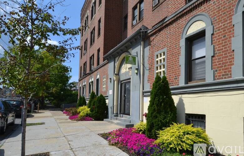A street view of a row of buildings with a car parked on the side.